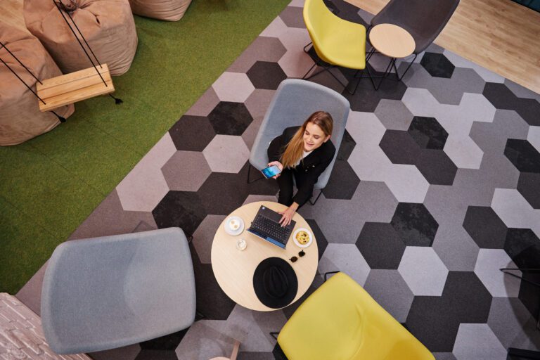 The Workin chill zone with a swing, poufs and hexagon-tiled floor